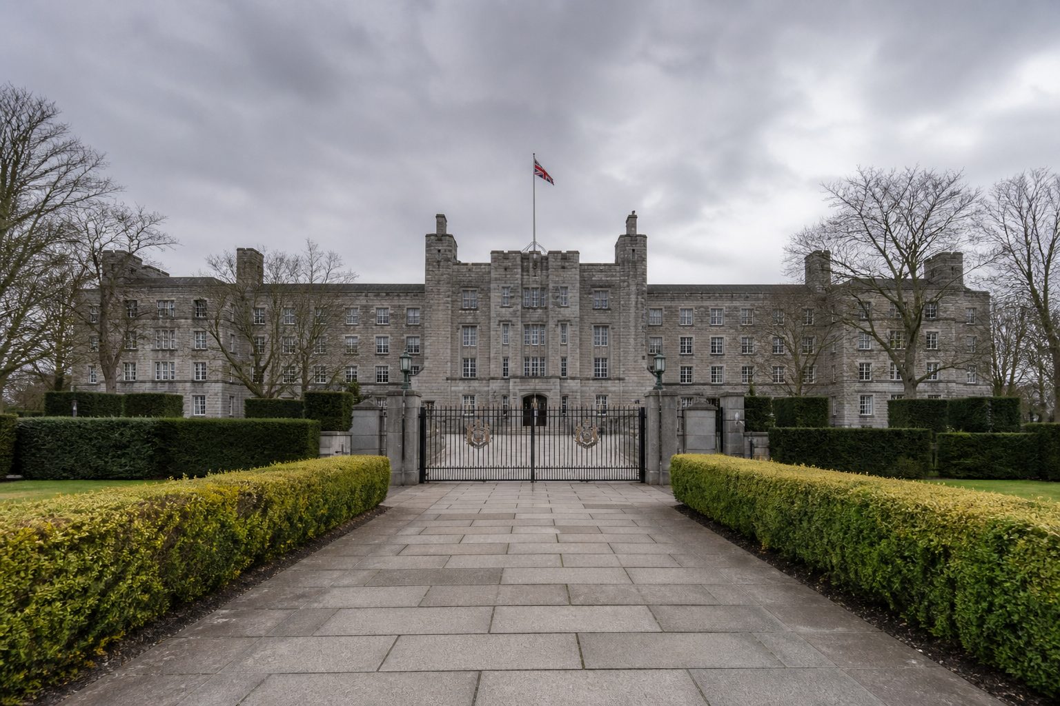 Grey stone defence ministry building under an overcast British sky.