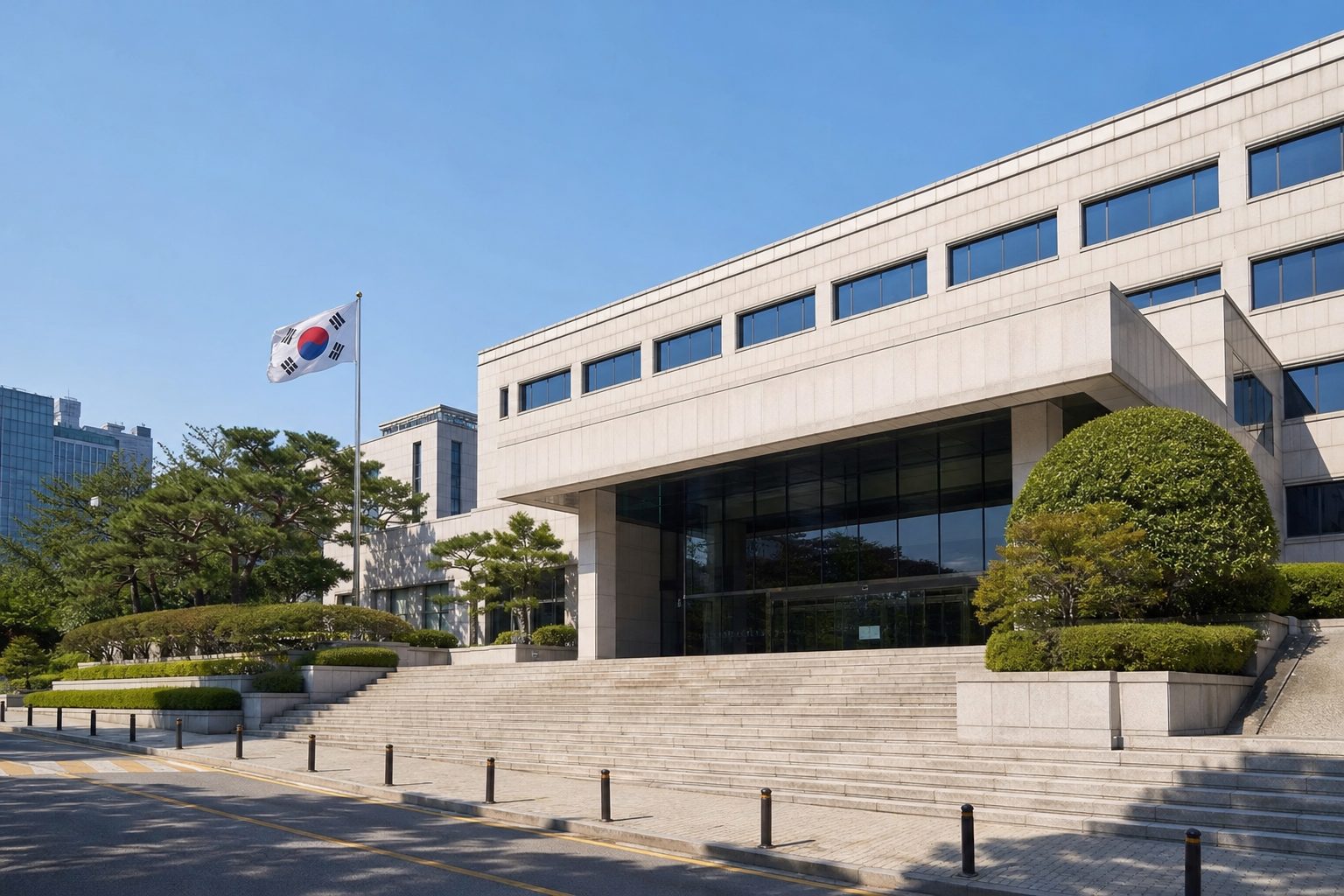 Entrance to a Korean government regulatory building in Seoul with stone steps and a flag.