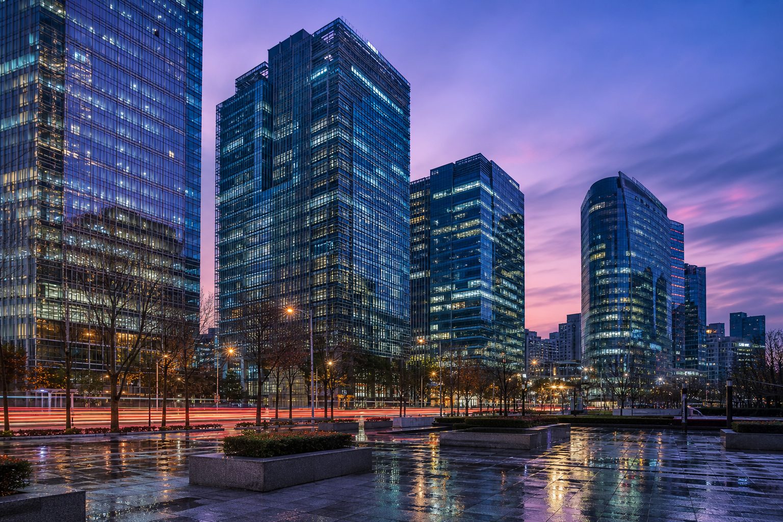Modern South Korean bank towers in a financial district at twilight with light trails on the street.